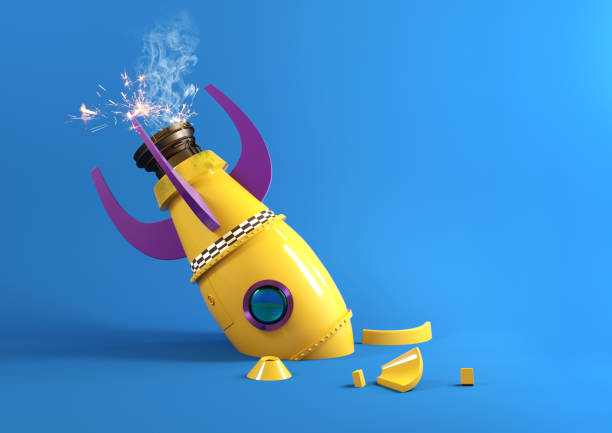 A crashed toy rocket emits sparks from its engine